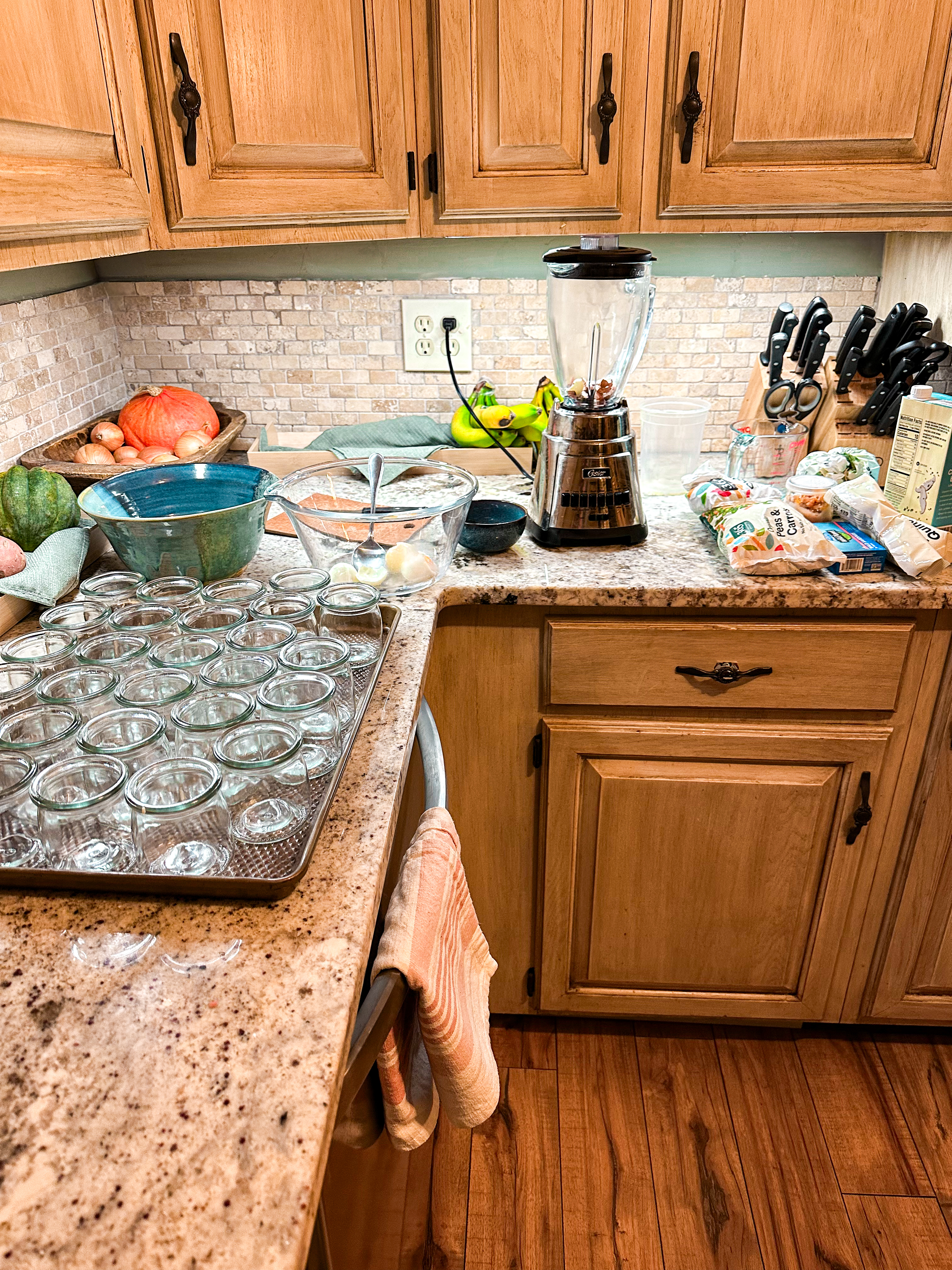 Kitchen counter with fresh ingredients for homemade cat food, including chicken, spinach, and eggs, ready for preparation.